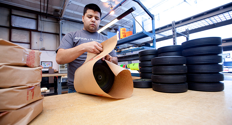 An SAIC employee in Chambersburg, PA, works on a logistic project, packaging and shipping tires.