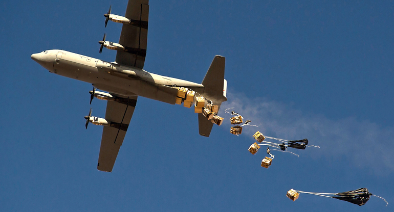 Plane dropping off packages in the sky