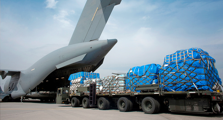loading a plane with a truck load of supplies and packages