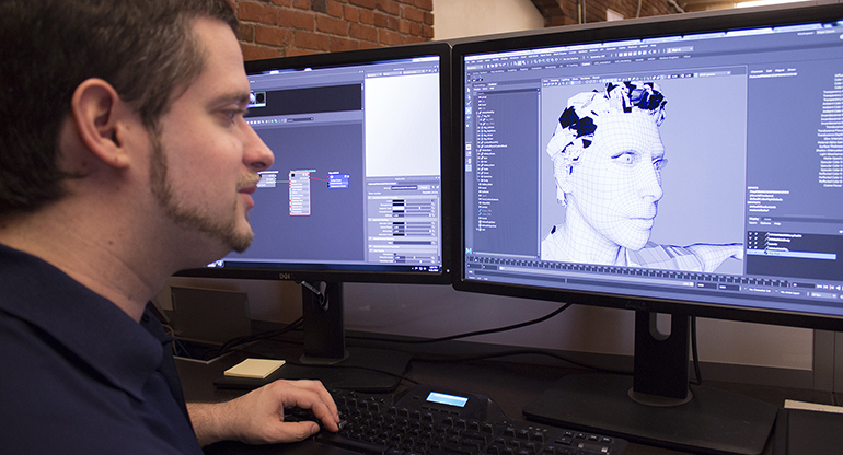 feature_gaming_body2 An SAIC character modeler, Joel Ryan, works on a design at his workstation.